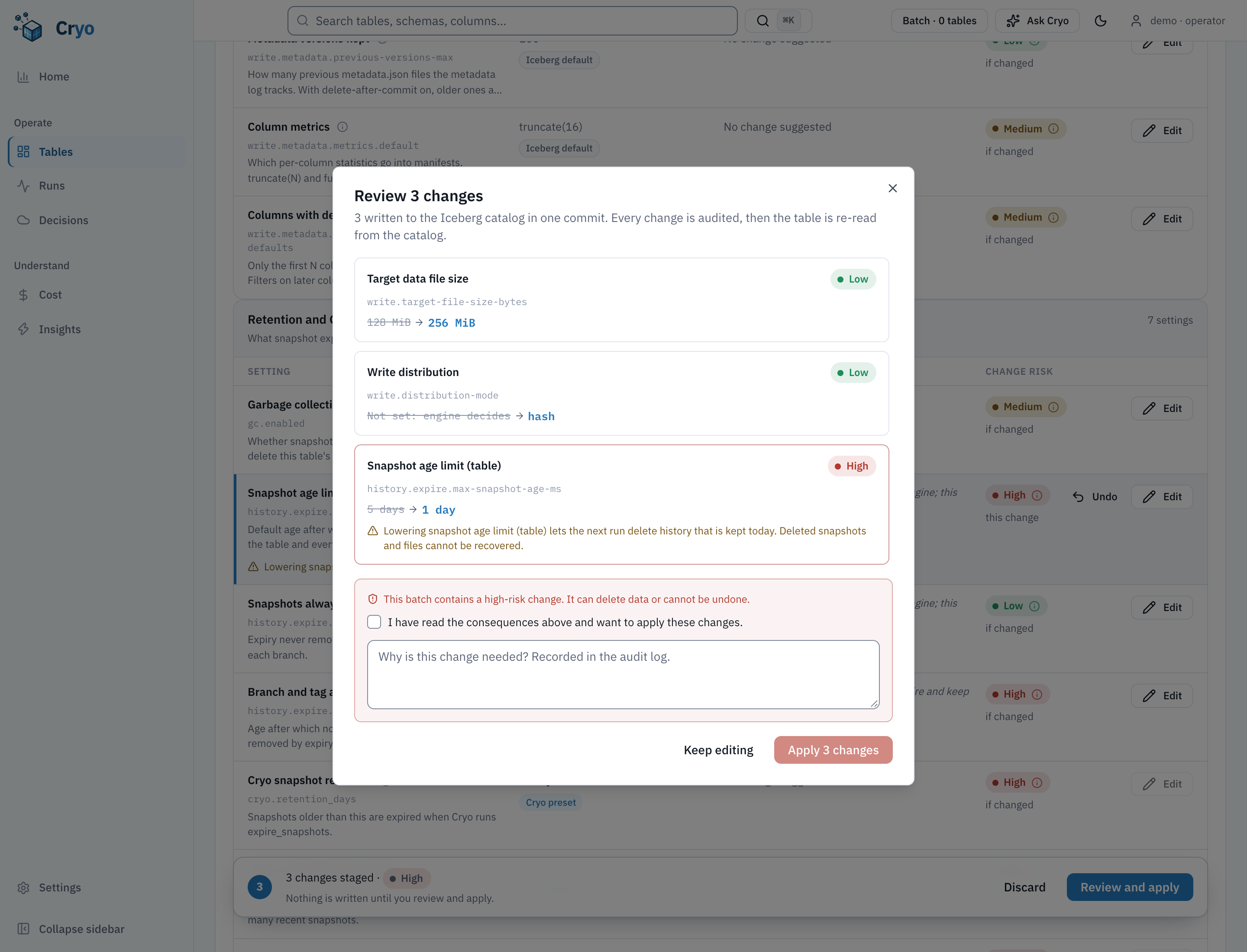 Review dialog for three staged changes: write.target-file-size-bytes to the recommended value, write.distribution-mode to the recommended value, and history.expire.max-snapshot-age-ms to 1 day. A warning reads that this batch contains a high-risk change, with a reason field and an acknowledgement checkbox.